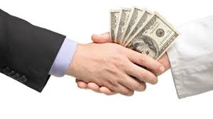 Hands counting cash beside a calculator and business documents